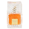 A clear glass perfume bottle with a transparent cap and orange liquid inside, featuring a gold label with Arabic text and the brand name Khamrah, on a plain white background.