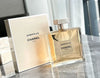 Chanel Gabrielle perfume bottle and packaging on a reflective surface