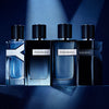 Four Yves Saint Laurent perfume bottles on a dark blue background