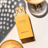 Gold perfume bottle labeled 'Shaghaf Vanilla Toffee' by Swiss Arabian on a light surface.