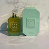Green perfume bottle and packaging with 'KAY ALI' branding on a marble surface.