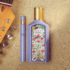 Gucci Flora perfume bottle and travel-sized version on a textured surface with guitar headstock.