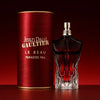 Jean Paul Gaultier perfume bottle and packaging on a red background