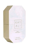 Kayali Déjavli White Flower Eau de Parfum bottle packaging, featuring a white faceted geometric box with a metallic gold side panel and gold lettering.