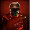 Parfum bottle labeled 'Stronger with You' on a dark background