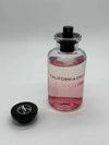 Perfume bottle labeled 'California Dream' by Louis Vuitton on a gray background