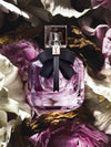 Perfume bottle with a black bow on flowers