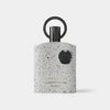 Perfume bottle with speckled design and black cap on a white background
