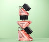 Prada perfume bottles stacked on a light green background