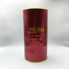 Red cylindrical container with gold text and design, featuring the brand 'Jean Paul Gaultier'.