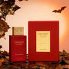 Swiss Arabian Shaghaf Old Afmar perfume bottle and its red packaging box, styled with autumn leaves and bat silhouettes against a warm orange background.