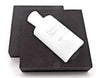 White bottle with text on a black square background
