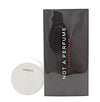 White spherical object with a black box labeled 'Not a Perfume' on a white background