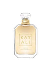A bottle of Kayali Deha Vu White Flower EDT perfume, featuring a clear glass bottle with a pale yellow liquid, a gold neck collar, and a clear faceted cap, set against a plain white background.